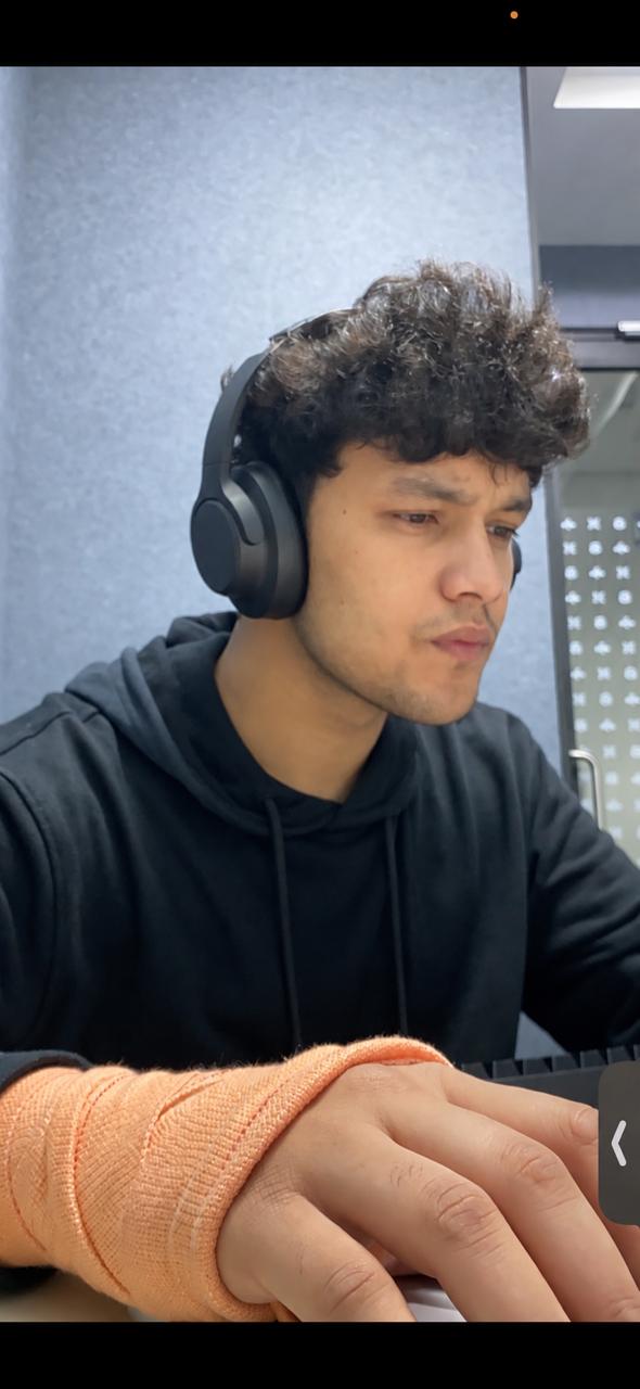 Yashwant wearing headphones while working at a desk